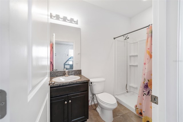 bathroom featuring toilet, vanity, tile patterned floors, and curtained shower