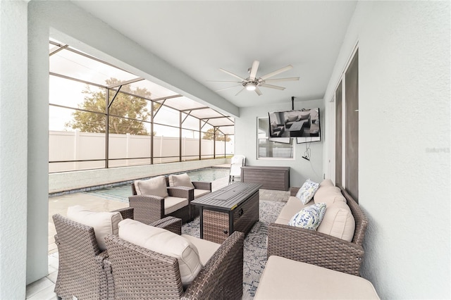 view of patio / terrace with ceiling fan, glass enclosure, and an outdoor living space