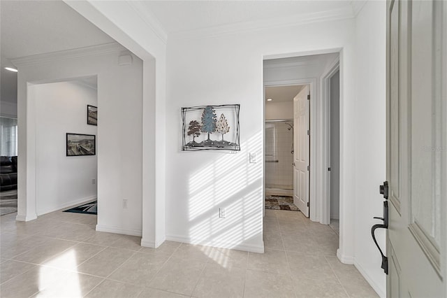 corridor featuring crown molding and light tile patterned floors