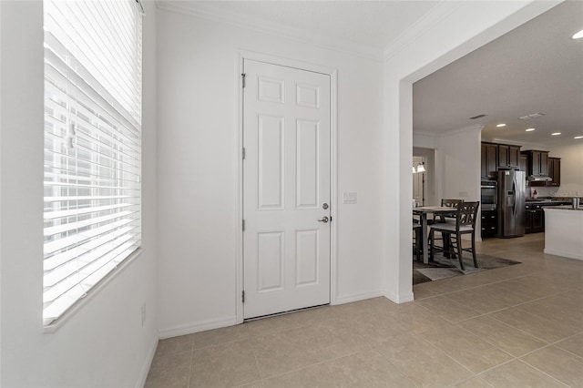 tiled entryway with ornamental molding