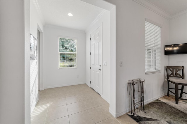 hallway with crown molding and light tile patterned floors