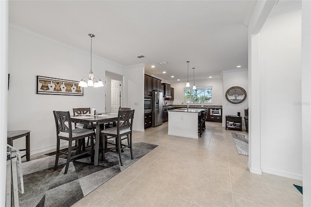 tiled dining room with sink, a notable chandelier, and crown molding