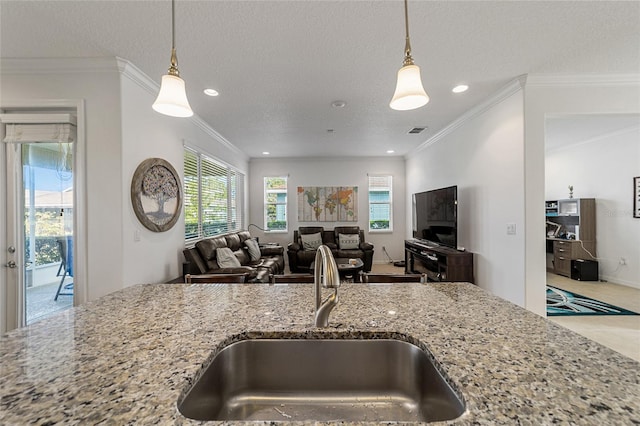 kitchen with crown molding, a textured ceiling, sink, and light stone counters