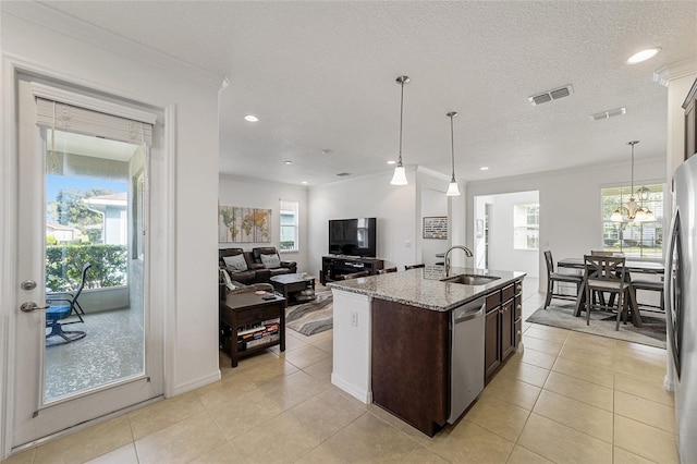 kitchen with sink, dishwasher, and a healthy amount of sunlight