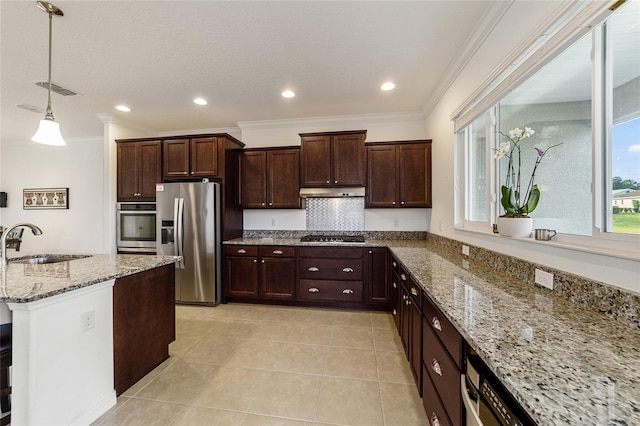 kitchen featuring appliances with stainless steel finishes, light stone countertops, ornamental molding, decorative light fixtures, and sink