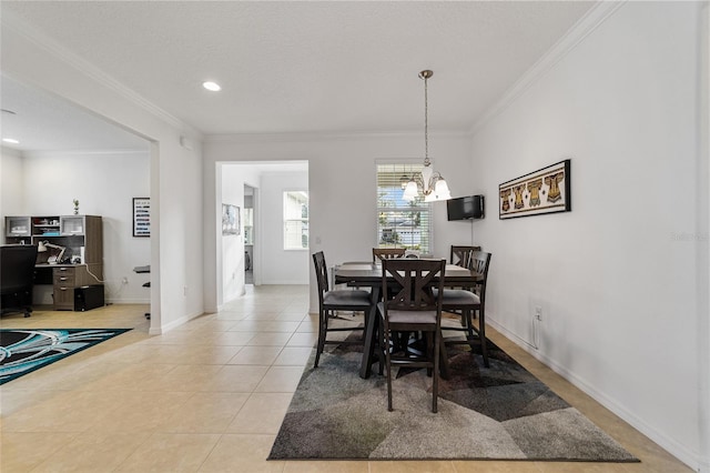 dining area featuring a textured ceiling, ornamental molding, light tile patterned floors, and a chandelier