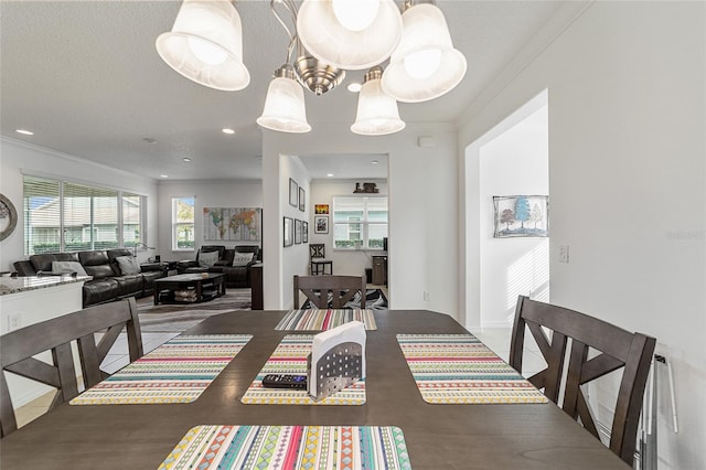 dining area featuring ornamental molding and a textured ceiling