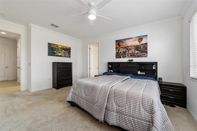 carpeted bedroom with ornamental molding, multiple windows, a textured ceiling, and ceiling fan