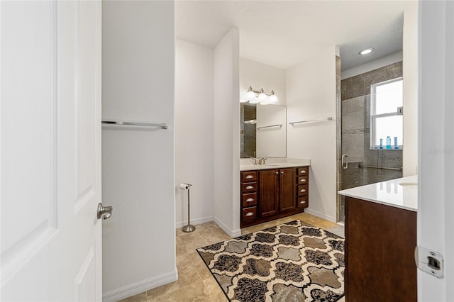 bathroom with vanity, tile patterned flooring, and a shower with door