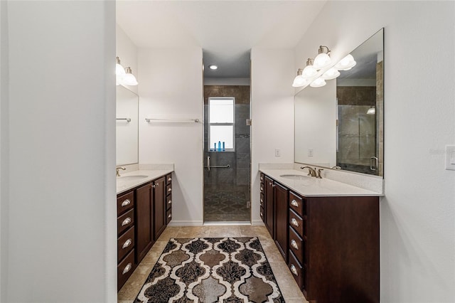 bathroom featuring a shower with door, vanity, and tile patterned floors