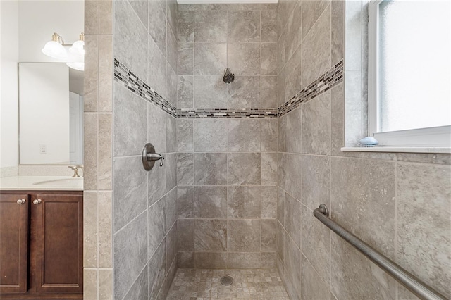 bathroom featuring vanity and a tile shower