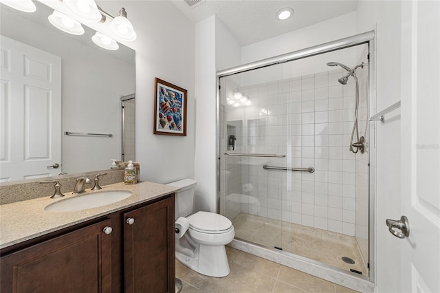 bathroom featuring a shower with door, vanity, toilet, and tile patterned flooring