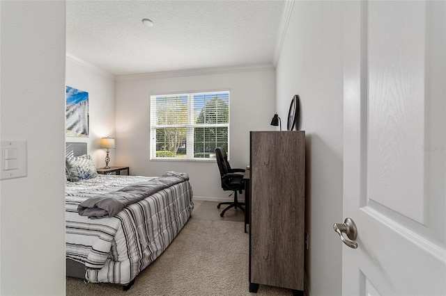 carpeted bedroom with ornamental molding and a textured ceiling