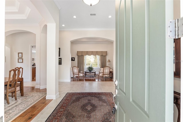 corridor with crown molding and light hardwood / wood-style flooring