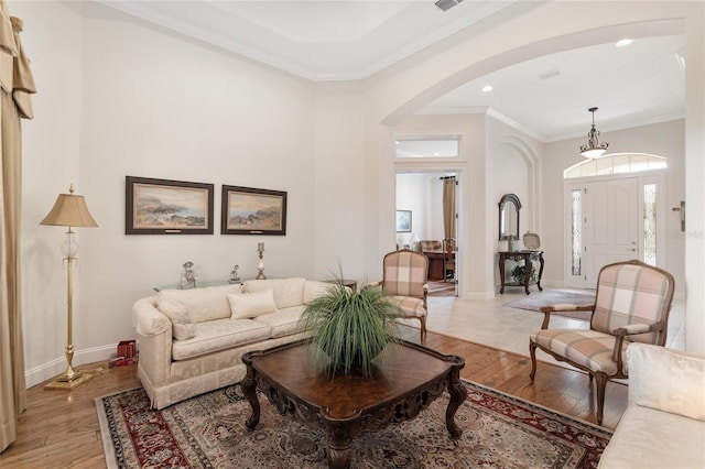 living room featuring light wood-type flooring and ornamental molding