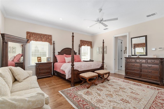 bedroom featuring ornamental molding, light wood-type flooring, and ceiling fan