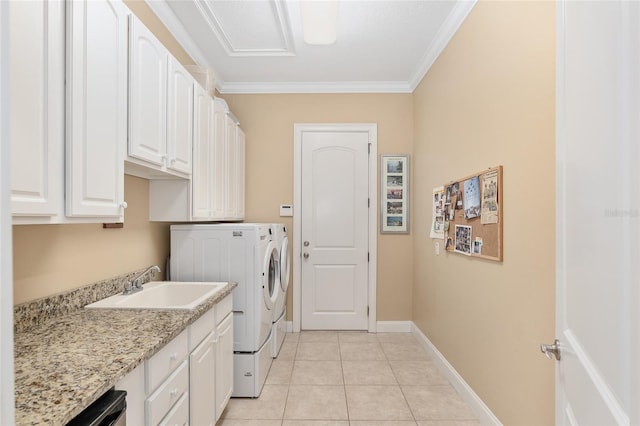 laundry area featuring cabinets, sink, ornamental molding, light tile patterned flooring, and independent washer and dryer