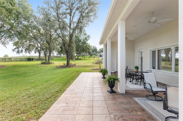 view of yard featuring a patio area and ceiling fan