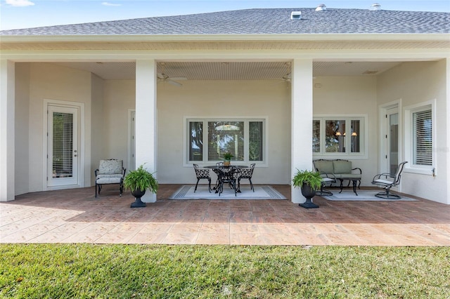 back of property with ceiling fan and a patio