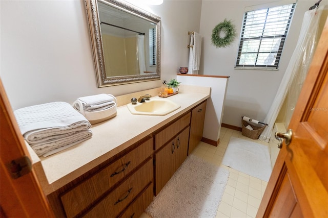 bathroom featuring walk in shower, vanity, and tile patterned floors