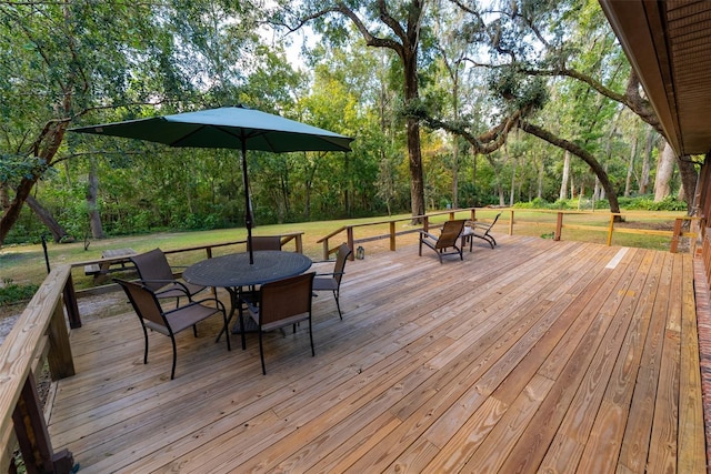 wooden deck featuring a lawn