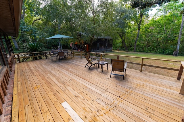 wooden deck featuring a lawn