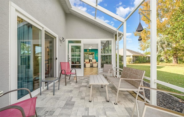 sunroom / solarium featuring lofted ceiling