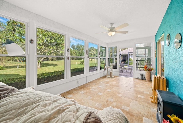 sunroom / solarium featuring ceiling fan and plenty of natural light