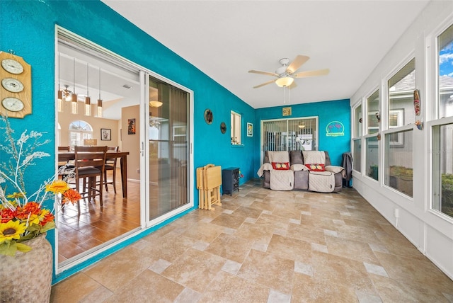 sunroom featuring ceiling fan