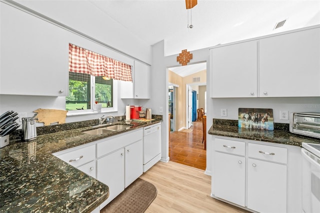 kitchen with sink, white cabinets, dark stone countertops, white appliances, and light hardwood / wood-style flooring