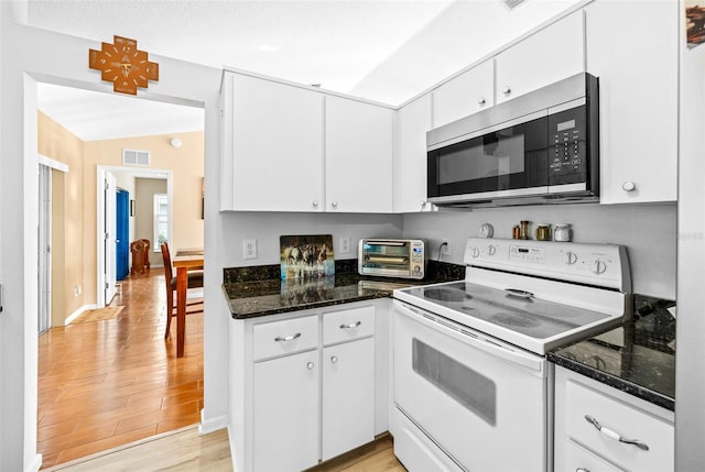 kitchen featuring white cabinets, light hardwood / wood-style floors, a textured ceiling, and white range with electric stovetop