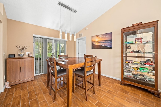 dining room with hardwood / wood-style flooring and lofted ceiling