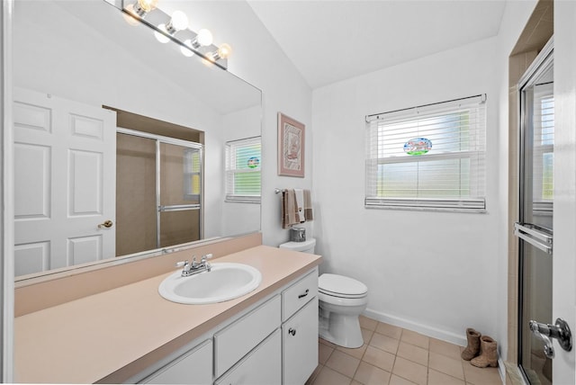 bathroom featuring toilet, vanity, vaulted ceiling, and a healthy amount of sunlight