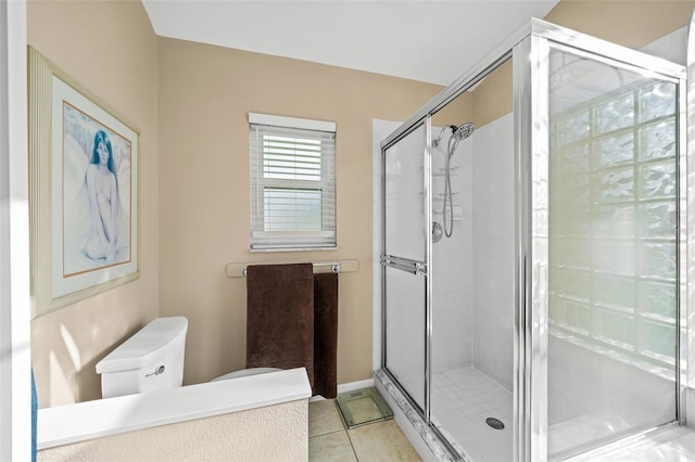 bathroom featuring tile patterned flooring, an enclosed shower, and toilet