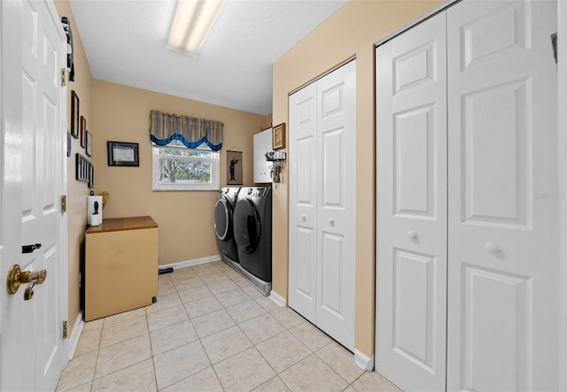 laundry area featuring separate washer and dryer and light tile patterned floors