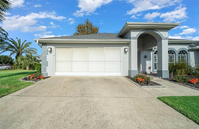 view of front of property featuring a garage and a front yard