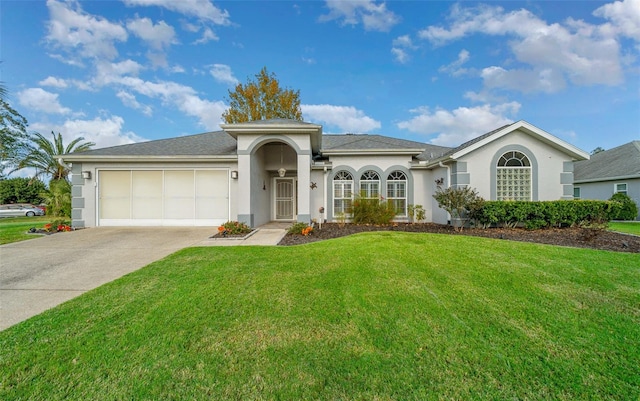 single story home featuring a garage and a front yard