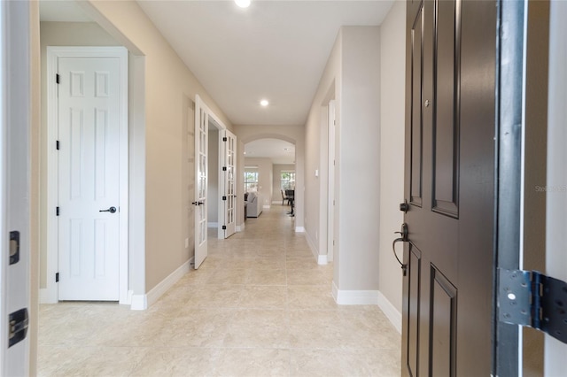 corridor with light tile patterned flooring