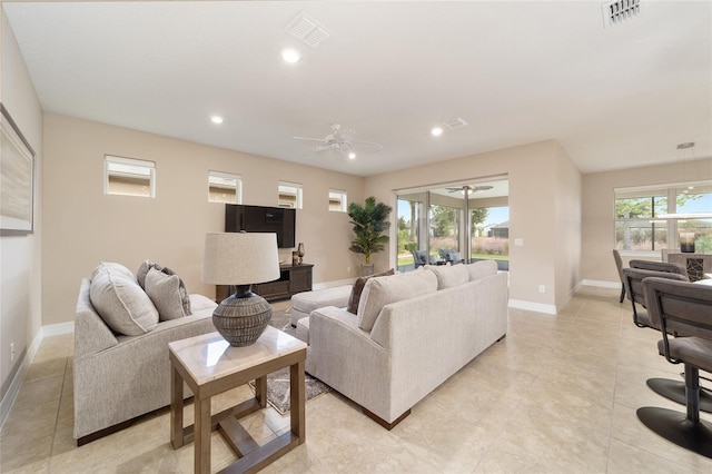 tiled living room with ceiling fan