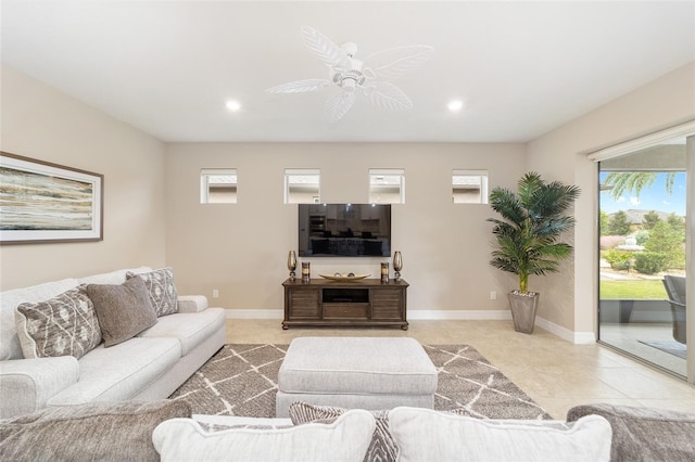 living room featuring ceiling fan and a healthy amount of sunlight