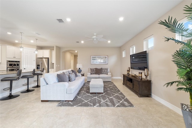 living room featuring ceiling fan and light tile patterned floors