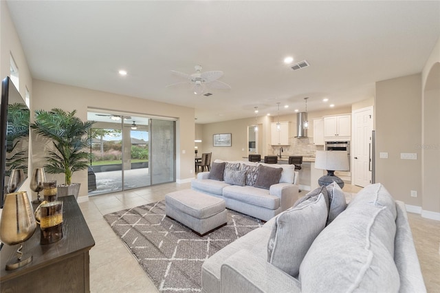 living room featuring light tile patterned flooring and ceiling fan