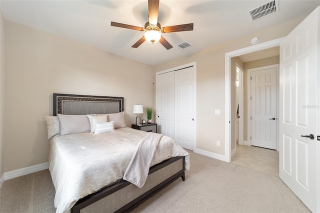 carpeted bedroom with ceiling fan and a closet