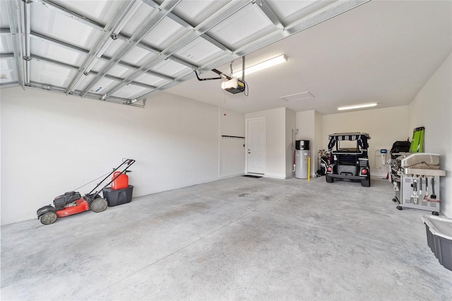 garage with a garage door opener and water heater