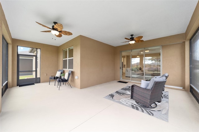 sunroom featuring ceiling fan