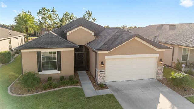 view of front of home featuring a garage and a front lawn