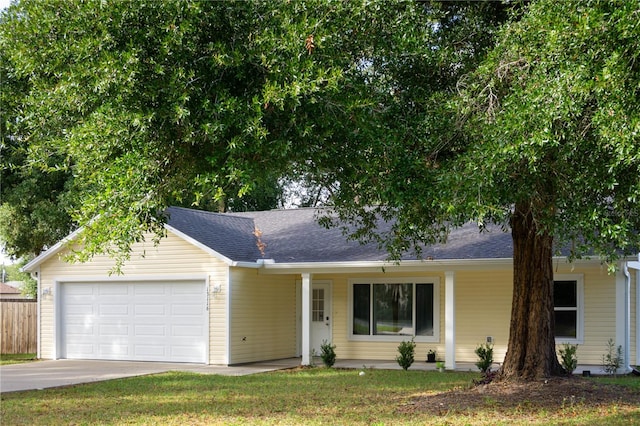 ranch-style home featuring a garage and a front lawn