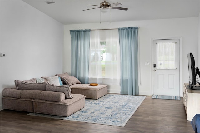 living room with ceiling fan and dark wood-type flooring