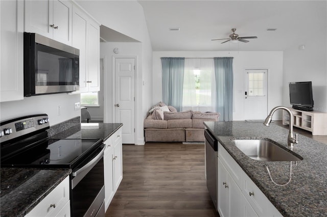 kitchen with a wealth of natural light, sink, white cabinets, and stainless steel appliances