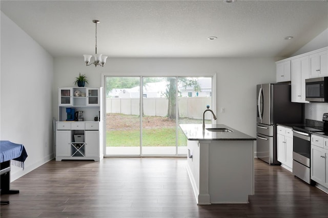 kitchen featuring a center island with sink, sink, white cabinetry, and stainless steel appliances